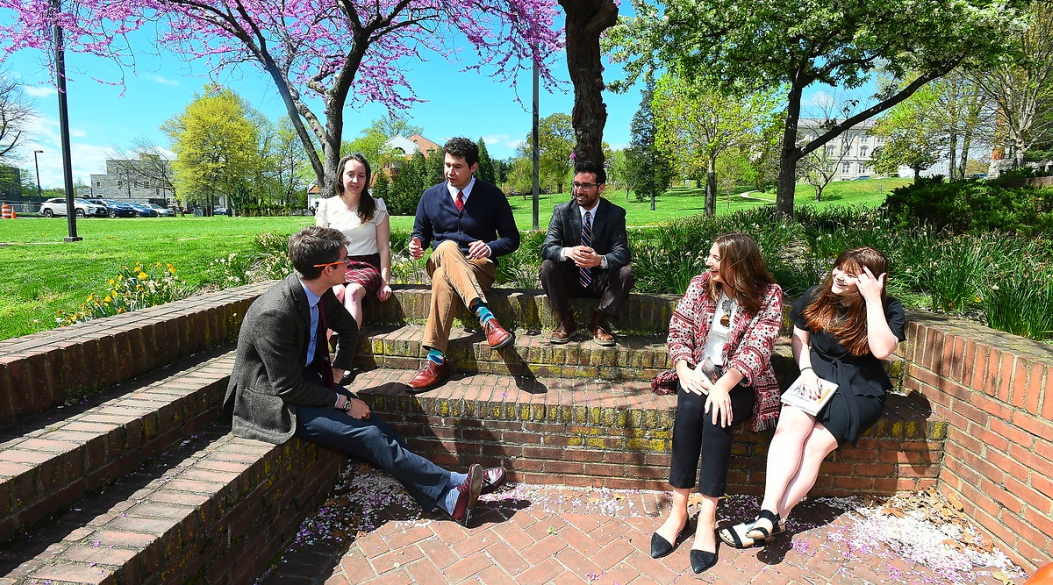 Male and female student talking outside the School of Philosophy