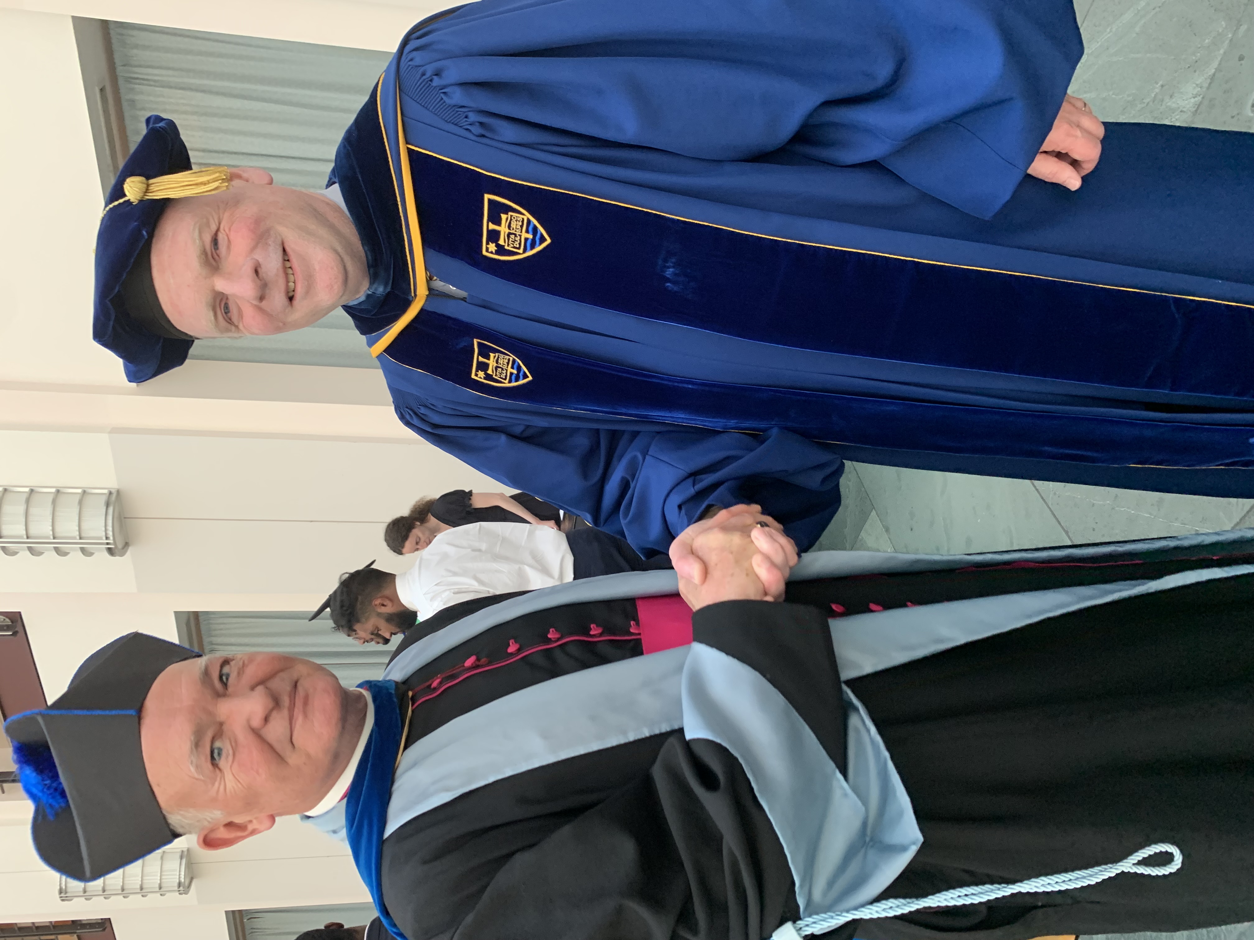 Msgr. Watkins shaking hands with Dean Lewis