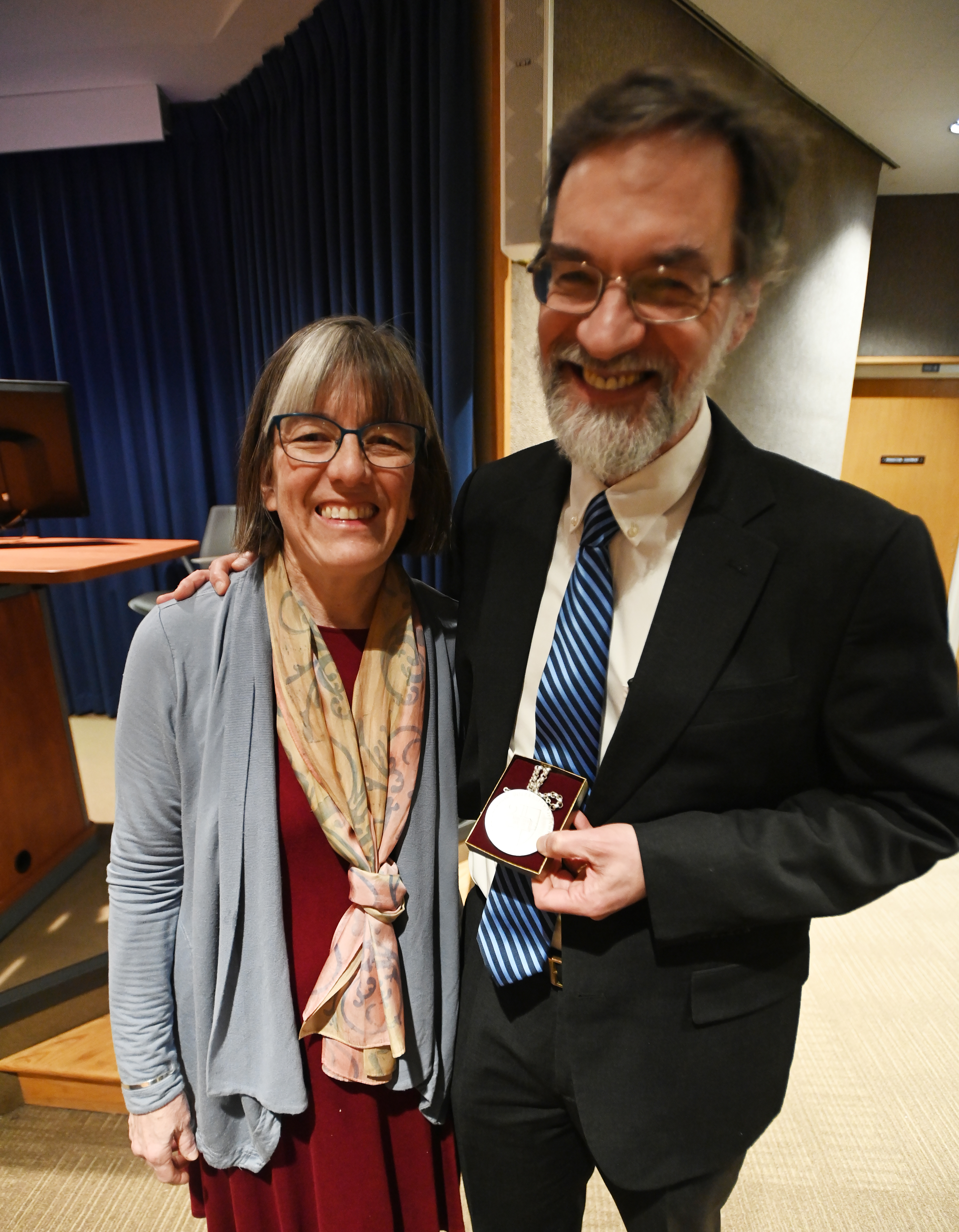 Dr. Gorman and his wife smile with the medallion.
